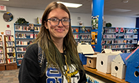  A young woman smiles in the school library.